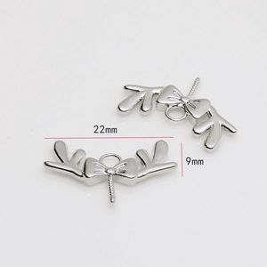 Detailed view of silver deer antler bow jewelry charms with 22mm x 9mm dimensions