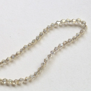 Macro shot of 4mm champagne faceted bicone crystal beads for DIY jewelry making