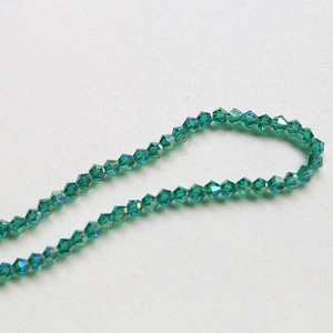 Macro shot of 4mm faceted green crystal beads with AB coating for DIY jewelry making