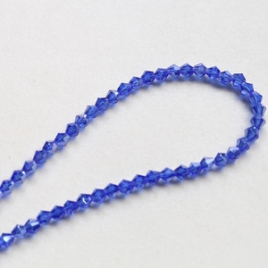 Close-up of 4mm faceted dark blue crystal glass spacer beads for DIY jewelry making