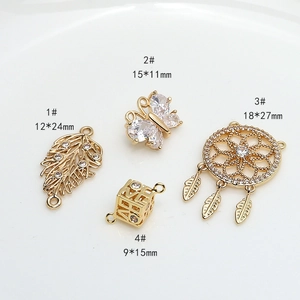 Detail view of gold-plated dreamcatcher butterfly and zircon pendants for DIY necklaces