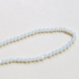 Close-up of 4mm faceted opal white bicone crystal beads for DIY jewelry making