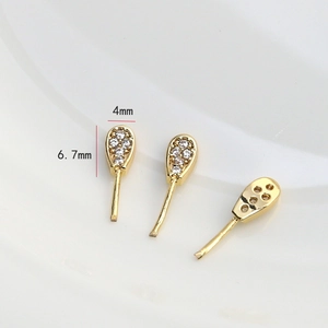 Macro view of gold-plated rabbit ear components with micro-pave zircons for DIY jewelry