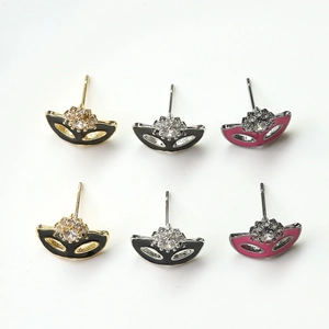Detail of ziron-inlaid fox mask earrings in gold, silver, and dark silver finishes