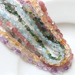 Macro shot of irregular natural amethyst and citrine tumbled stone beads for DIY jewelry