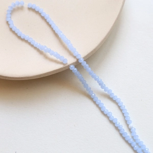 Macro shot of 3mm light blue faceted crystal spacer beads for DIY jewelry making