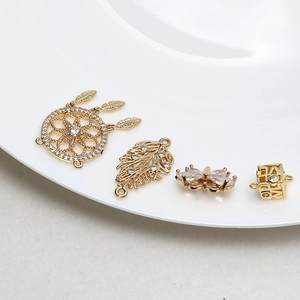 Macro detail of gold-plated dreamcatcher and butterfly connectors with cubic zirconia
