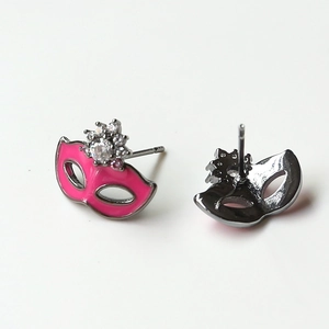 Detailed view of pink enamel fox mask earrings with sparkling zircon crown inlay