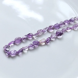 Macro shot of polished irregular amethyst crystal beads for DIY jewelry making