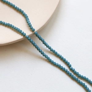 Macro shot of 3mm teal faceted crystal rondelle beads for DIY jewelry making