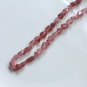 Detailed macro view of natural irregular pink strawberry quartz beads for DIY jewelry making