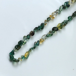Macro view of multi-color irregular natural amethyst and citrine polished stone beads