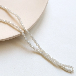 Macro view of 3mm cream faceted crystal glass beads for DIY jewelry making and crafts