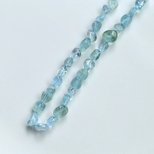 Macro view of light blue irregular natural stone beads for DIY jewelry making