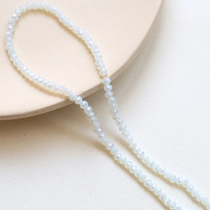 Detailed macro of 3mm faceted clear AB crystal rondelle beads for DIY jewelry making