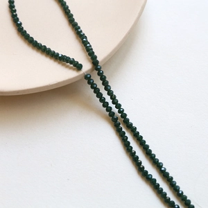 Macro shot of 3mm dark green faceted crystal beads for DIY handmade jewelry crafts
