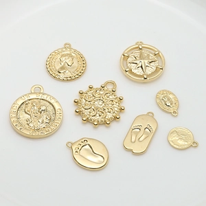 Set of gold vintage style pendants with portrait, star, and footprint designs for jewelry