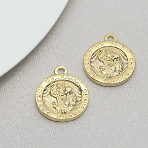 Detailed macro view of gold Saint Christopher round pendant with religious embossing