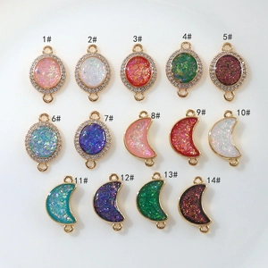 Selection of 14 gold-plated moon and oval charms with zircon and glitter resin inlay