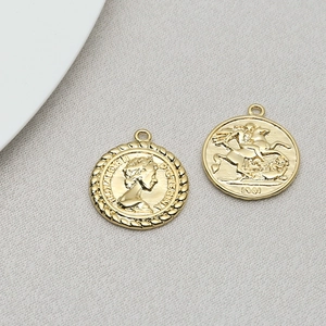 Close-up of golden coin pendants featuring Queen Elizabeth II and 1901 St George dragon