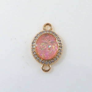 Detail of pink opal pendant with zircon halo and gold plated double loop connectors