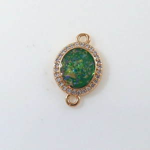 Detail of gold-plated moon charm with green sequins and white zircon for DIY jewelry