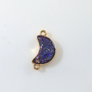 Close-up of purple glitter crescent moon connector charm with gold metal loops for DIY jewelry