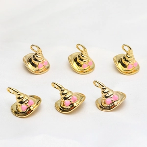 Detailed view of six gold wizard hat pendants with pink bow accents for DIY jewelry