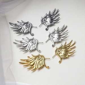 Three pairs of metal angel wing charms in gold, silver, and black for DIY jewelry making