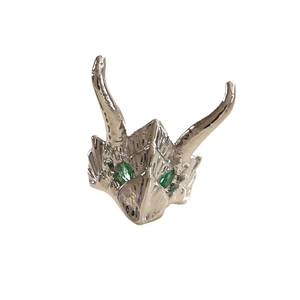 Silver dragon head accessory with vibrant green gemstone eyes in high-gloss finish