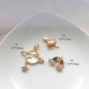 Macro shot of gold-plated shell and zircon charms for jewelry making including star and rainbow