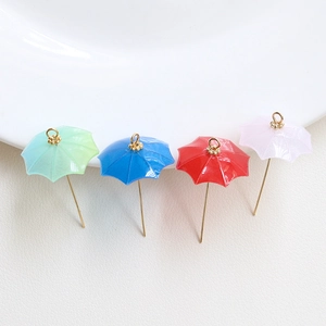 Detailed view of colorful translucent umbrella charms for DIY jewelry and accessories