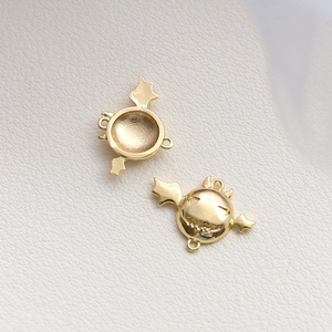 Detailed view of dual-sided gold devil bat pendants with smiling faces for DIY jewelry