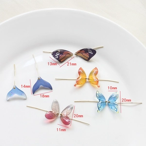 Macro view showing resin gradient butterfly wings and fish tails with size dimensions
