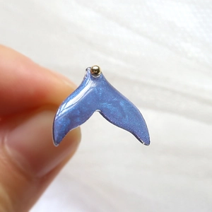 Macro shot of gradient blue and purple resin fish tail pendant with fine glitter detail