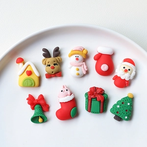 Macro shot of 9 assorted Christmas resin charms including Santa and snowman for DIY crafts