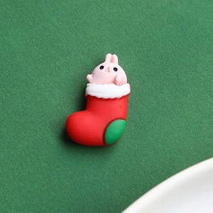 Detail of a pink bunny in a red Christmas stocking resin charm for DIY crafts