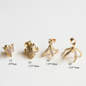 Detailed view of gold plated jewelry pendants with white zircon and crown cat designs