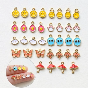 Mini gold-plated enamel charms including smiley face, butterfly, and leaf for DIY jewelry