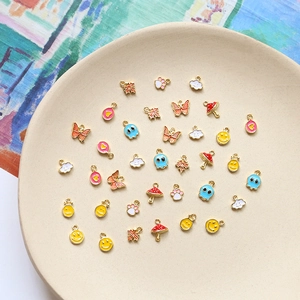 Mix of gold-plated mini charms including smiley face and butterfly for DIY jewelry making
