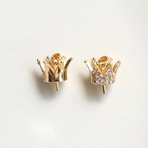Detail of gold crown charms with zircon inlay and polished surface for DIY jewelry