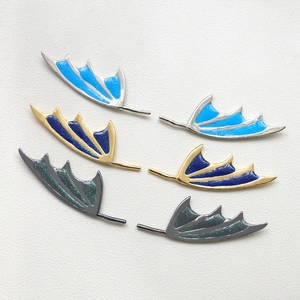 Three pairs of colorful dragon wing jewelry charms in gold and silver finish