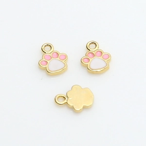 Detail of paw-shaped gold-plated charms with pink enamel inlay for DIY jewelry making