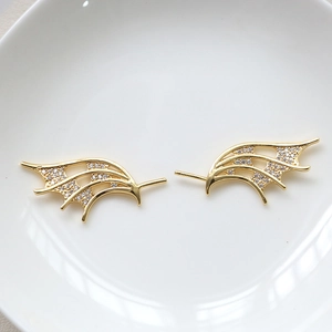 Macro shot of 18k gold plated hollow wings with cubic zirconia for DIY jewelry making