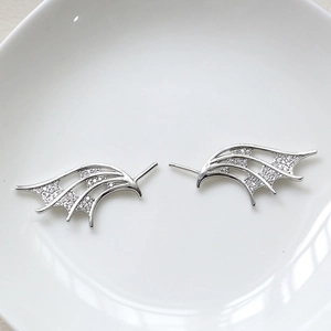 Detailed view of devil wing jewelry accessories with pavé cubic zirconia and silver finish