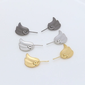 Polished metal fairy wing earrings in gold, silver, and black finish on white background