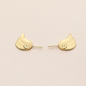 Detailed view of gold-plated fairy wing earrings with a smooth metallic luster