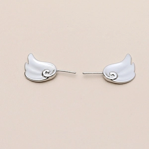 Detailed view of silver wing-shaped stud earrings with realistic feather textures