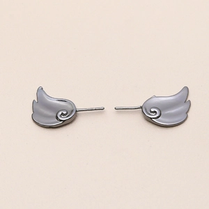 Detailed view of dark grey metallic wing earrings with cloud-inspired scrollwork design