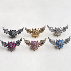 Detailed view of six colorful heart and wing shaped zircon pendants for DIY jewelry making